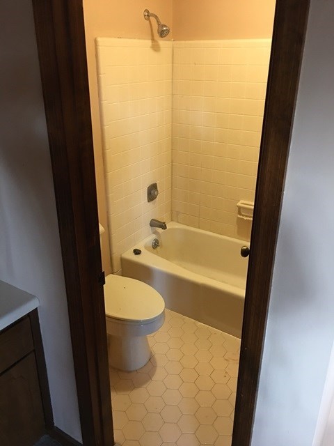 6445 Stapleton Road Macon, GA 31206 - Photo 11 of 22 a bathroom with a granite countertop toilet and a tub