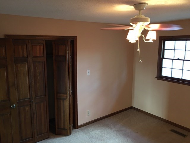 6445 Stapleton Road Macon, GA 31206 - Photo 12 of 22 a view of a chandelier fan and closet in a room