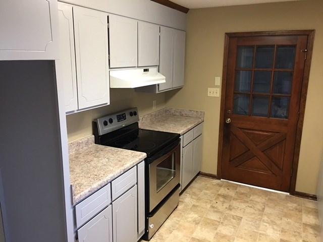 6445 Stapleton Road Macon, GA 31206 - Photo 3 of 22 a kitchen with granite countertop cabinets and steel appliances
