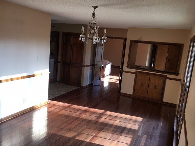 6445 Stapleton Road Macon, GA 31206 - Photo 5 of 22 a view of a livingroom with wooden floor and kitchen