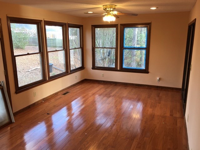 6445 Stapleton Road Macon, GA 31206 - Photo 8 of 22 a view of an empty room with wooden floor and a window