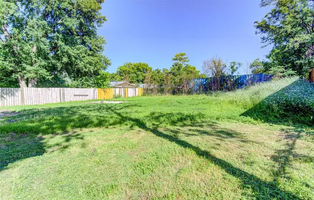 a view of a garden with a building in the background