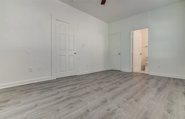 a view of an empty room and wooden floor