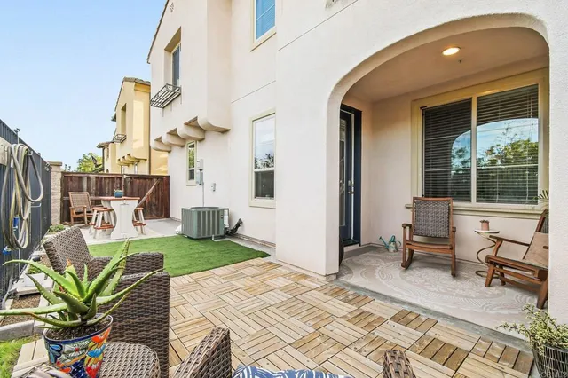 a view of a house with backyard porch and sitting area
