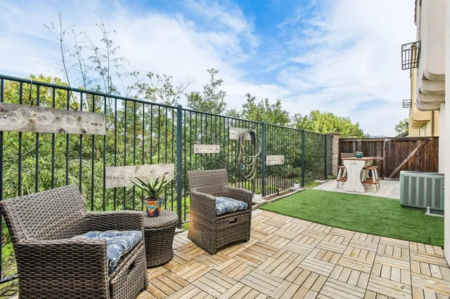 a view of a balcony with chair potted plants