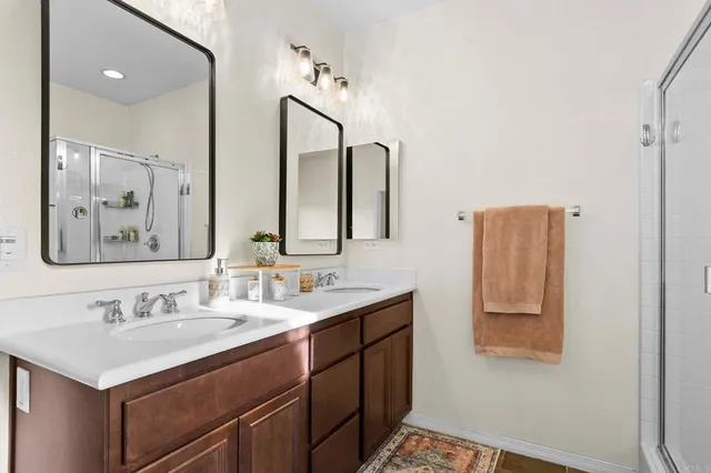 a bathroom with a sink vanity and mirror