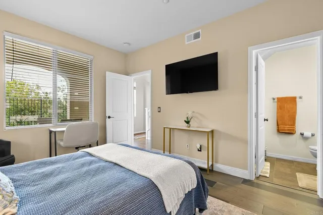 a bedroom with a bed and a television