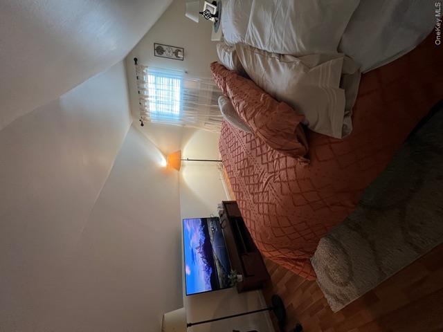 82 Westcott Street Inwood, NY 11096 - Photo 18 of 24 a bedroom with a bed and a lamp on dresser
