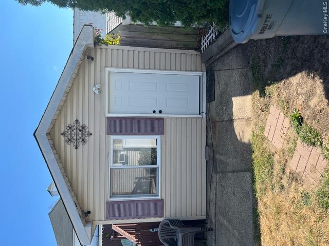 82 Westcott Street Inwood, NY 11096 - Photo 20 of 24 a view of a house with a yard