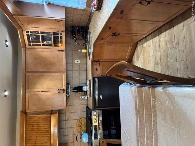 82 Westcott Street Inwood, NY 11096 - Photo 2 of 24 a kitchen with a sink stove and cabinets
