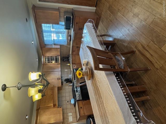82 Westcott Street Inwood, NY 11096 - Photo 3 of 24 a kitchen with a table chairs stove and cabinets