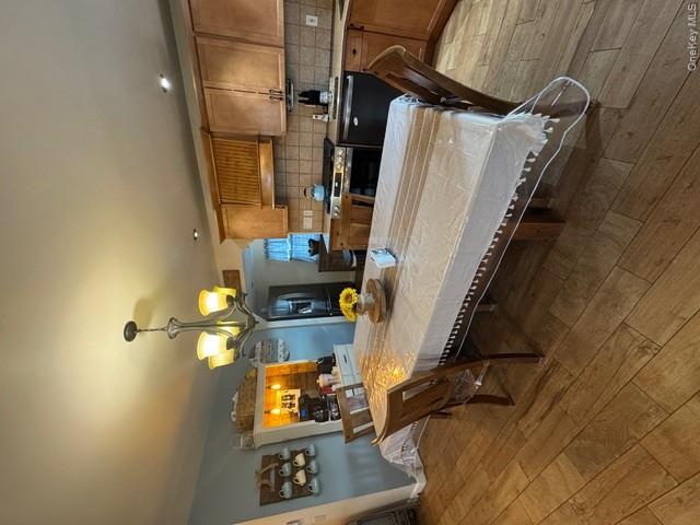 82 Westcott Street Inwood, NY 11096 - Photo 4 of 24 a dining room with a table chairs and a kitchen view
