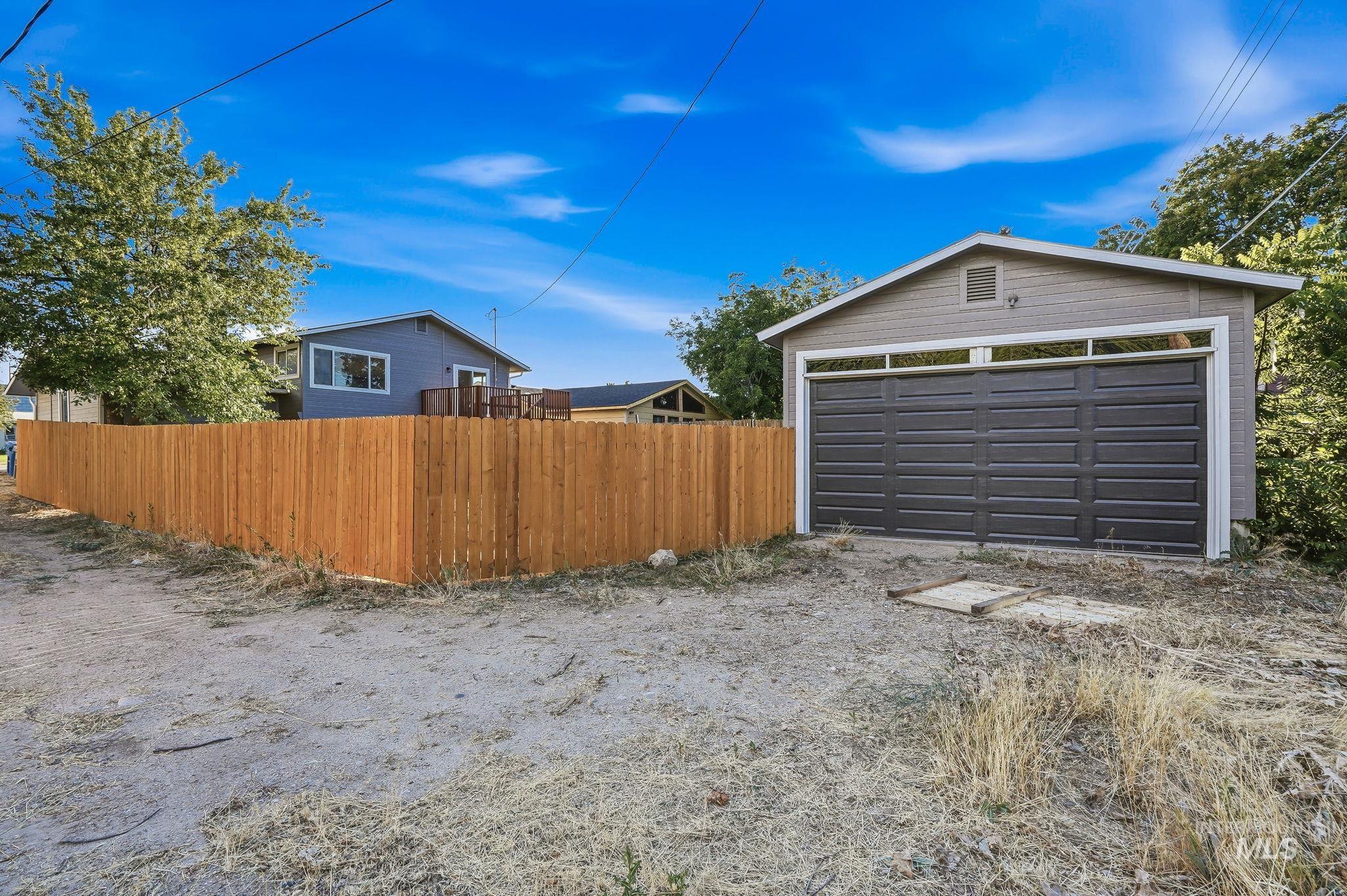 1990 Panama Street Boise, ID 83705 - Photo 50 of 50 Detached garage featuring panel garage door, upper transom windows, and horizontal siding