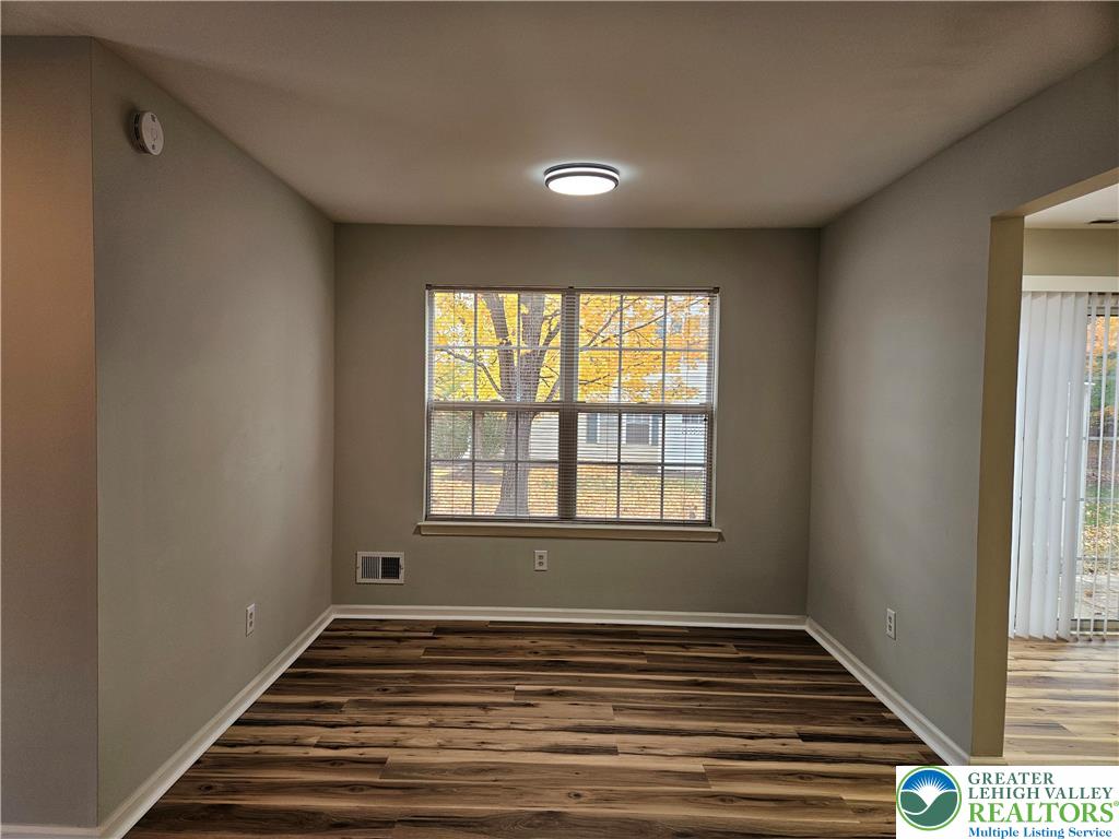 1876 Mansfield Street Hellertown, PA 18055 - Photo 3 of 19 a view of an empty room with wooden floor and a window