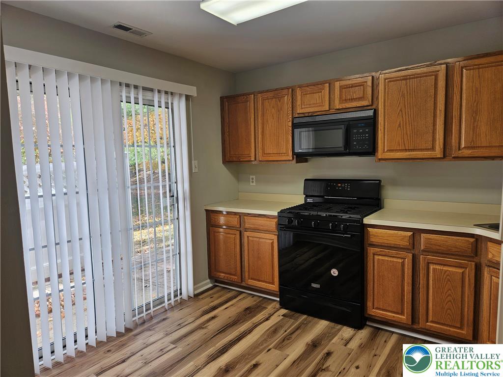 1876 Mansfield Street Hellertown, PA 18055 - Photo 9 of 19 a kitchen with stainless steel appliances granite countertop a stove a sink and a microwave