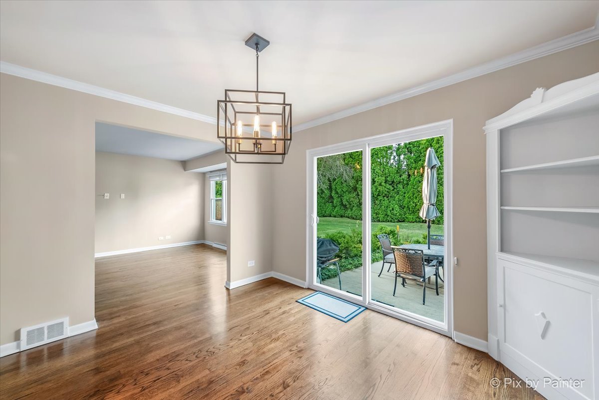 838 East Harriet Lane Barrington, IL 60010 - Photo 11 of 33 a view of empty room with wooden floor and floor to ceiling window