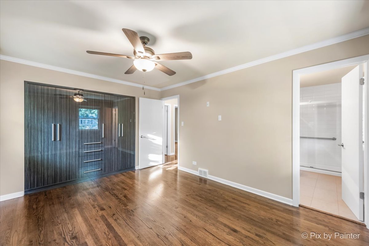 838 East Harriet Lane Barrington, IL 60010 - Photo 13 of 33 a view of an empty room with wooden floor and a ceiling fan