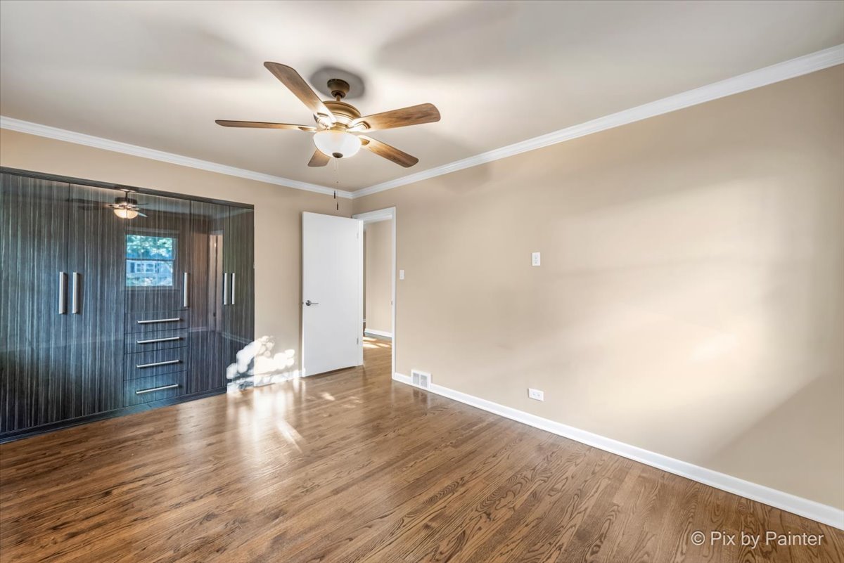 838 East Harriet Lane Barrington, IL 60010 - Photo 16 of 33 an empty room with wooden floor fan and windows