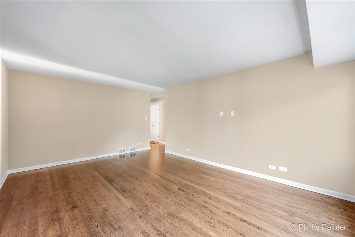 838 East Harriet Lane Barrington, IL 60010 - Photo 20 of 33 a view of an empty room with wooden floor