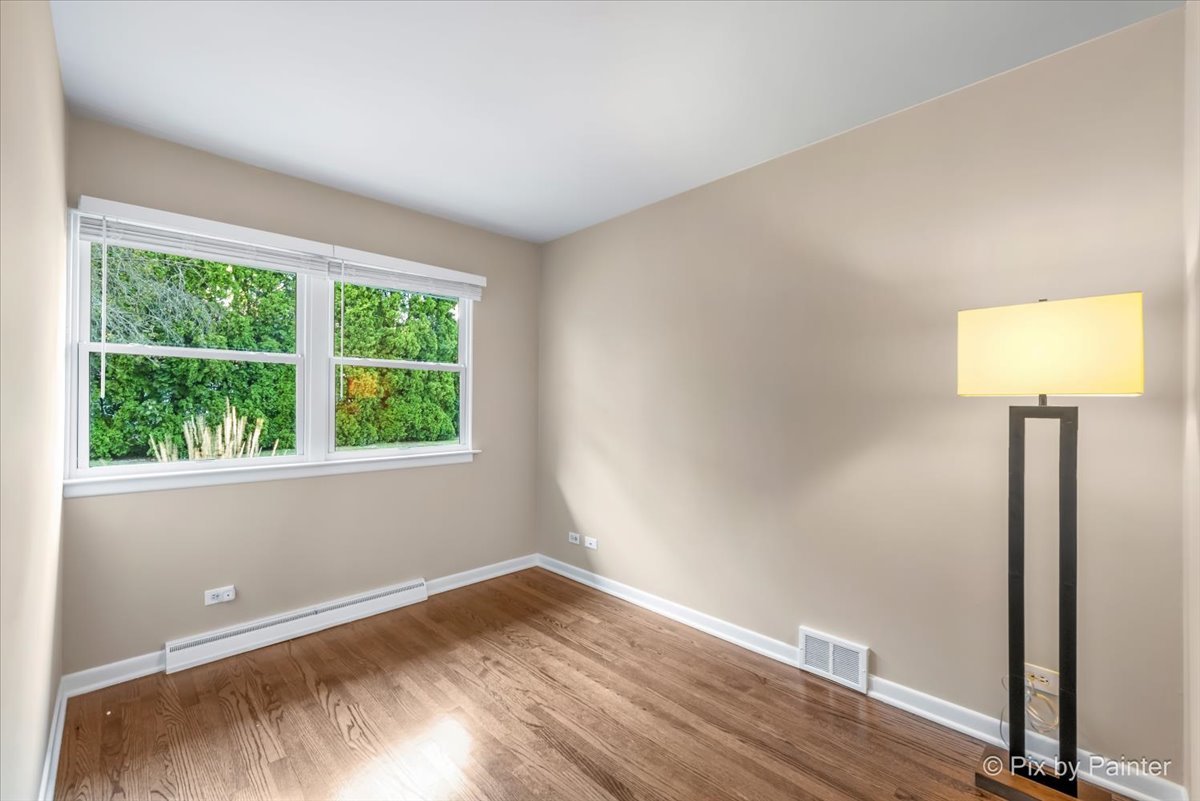 838 East Harriet Lane Barrington, IL 60010 - Photo 23 of 33 an empty room with wooden floor and windows
