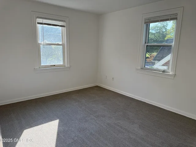 a view of a hallway view with wooden floor and staircase
