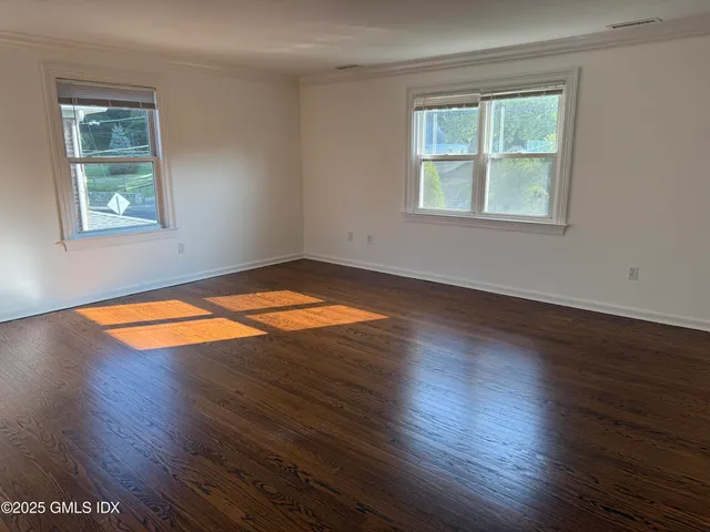 a view of a roof deck with the couches under an umbrella