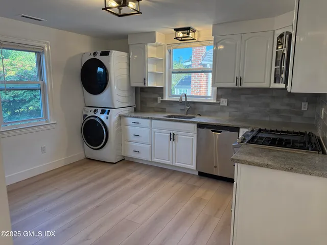 a kitchen with a stove a sink and a microwave