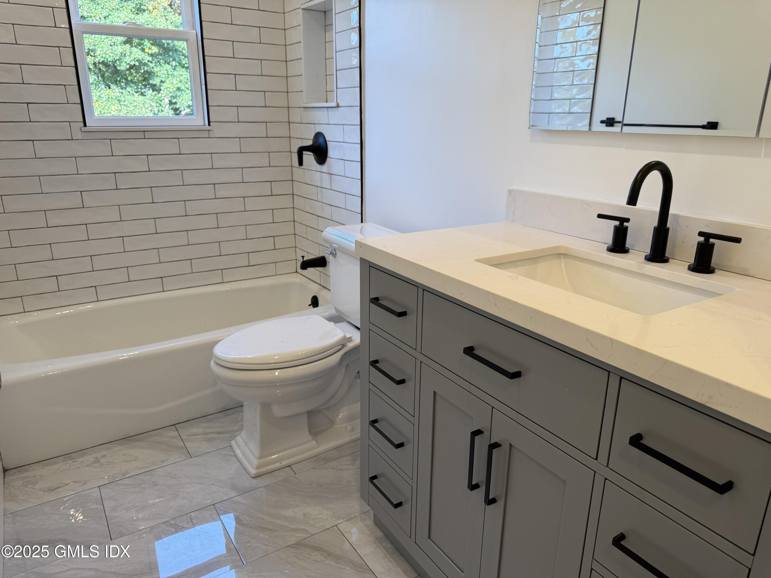 122 Pemberwick Road, Unit 2 Greenwich, CT 06831 - Photo 6 of 17 a bathroom with a sink a toilet and shower