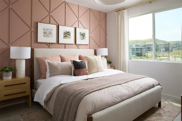 a large bed sitting in a bedroom next to a window