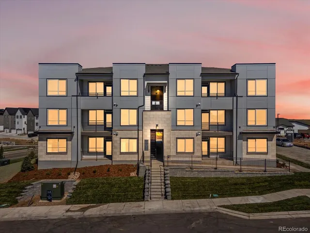 a front view of a residential apartment building with a yard