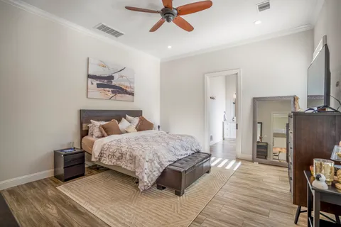 a bedroom with a bed and a chandelier