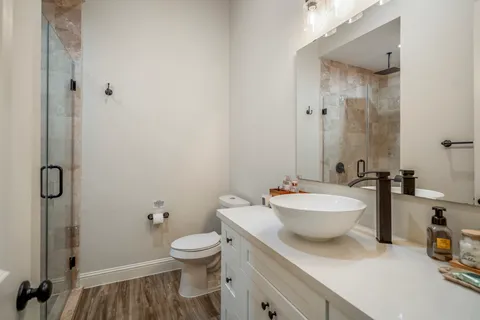 a bathroom with a toilet sink and mirror