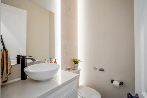 a bathroom with a toilet sink and mirror