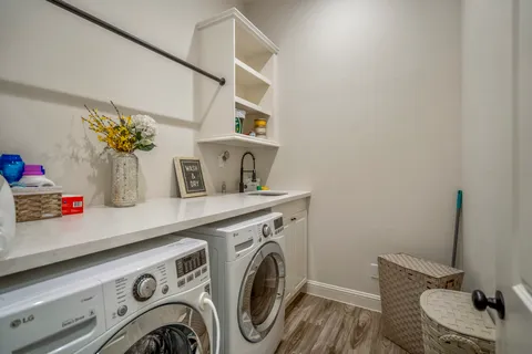 a utility room with sink dryer and washer