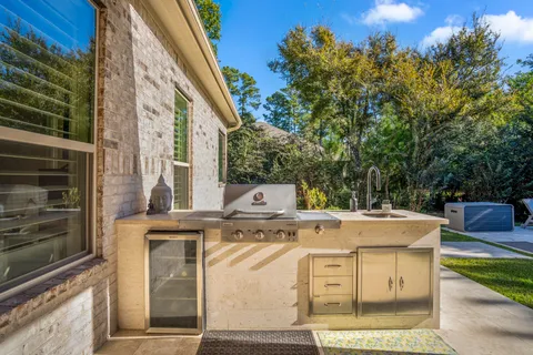 a view of a house with a sink and dishwasher with yard
