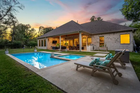 a view of a house with swimming pool and sitting area