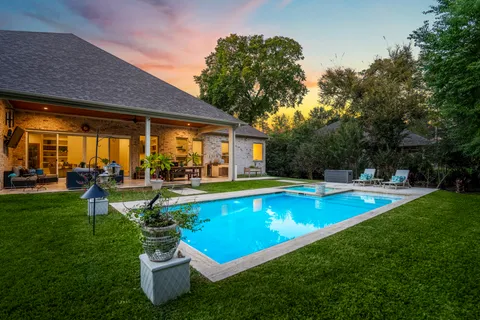 a view of a swimming pool with lounge chairs in the patio