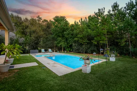 a view of a backyard with swimming pool