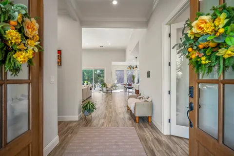 a hallway with a dining table and chairs
