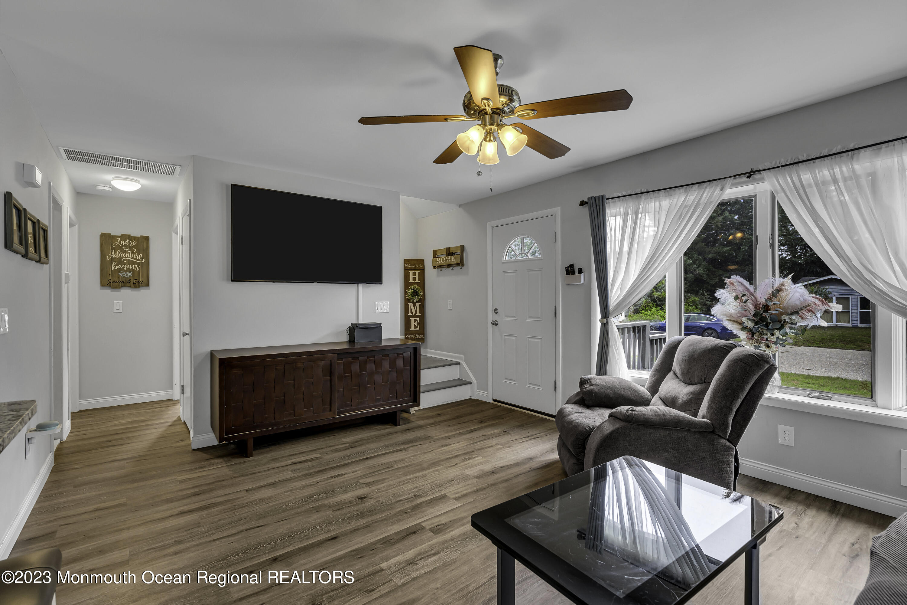 50 Central Avenue Waretown, NJ 08758 - Photo 11 of 35 a living room with furniture a flat screen tv and a large window
