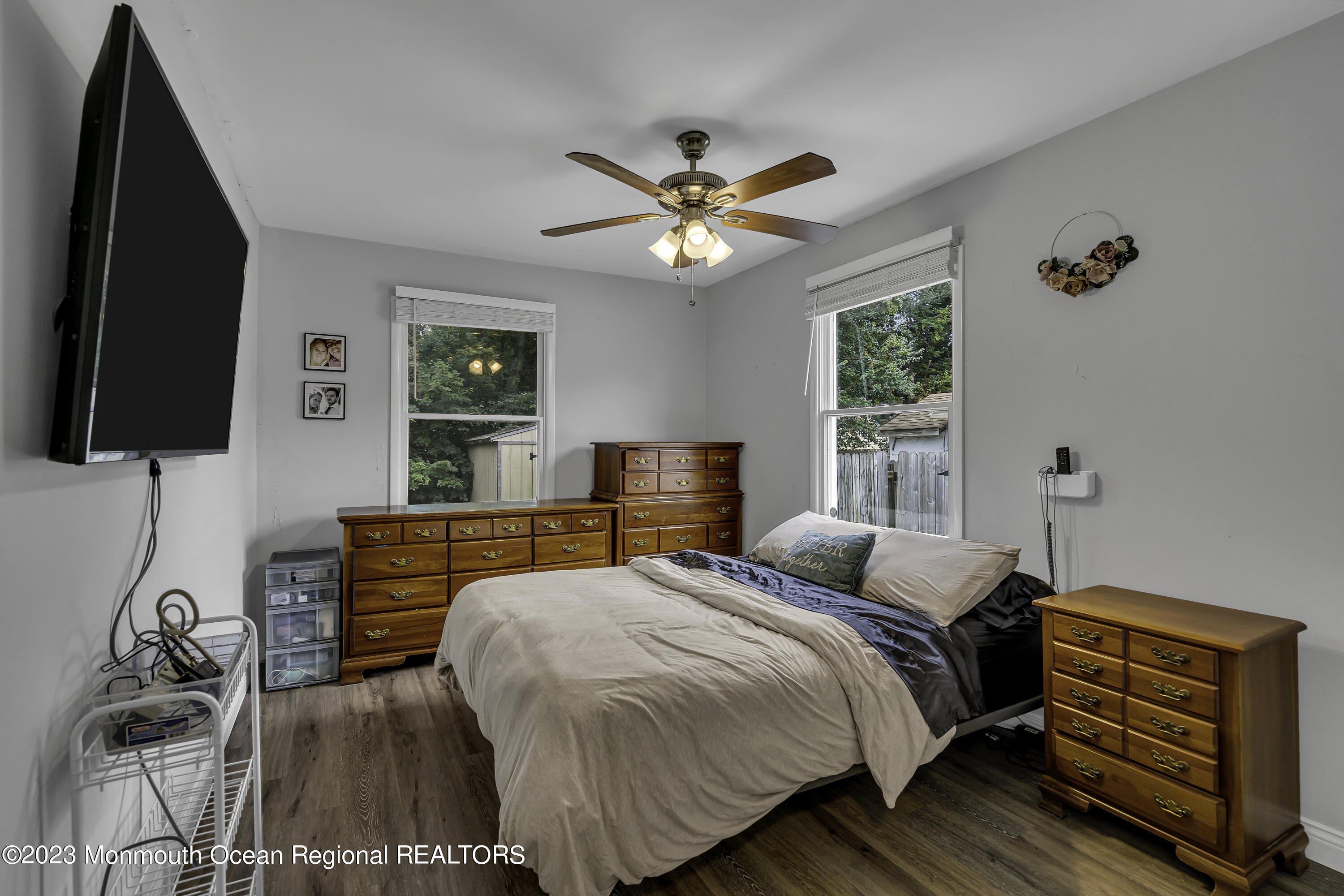 50 Central Avenue Waretown, NJ 08758 - Photo 23 of 35 a bedroom with a bed and a flat tv screen on the dresser