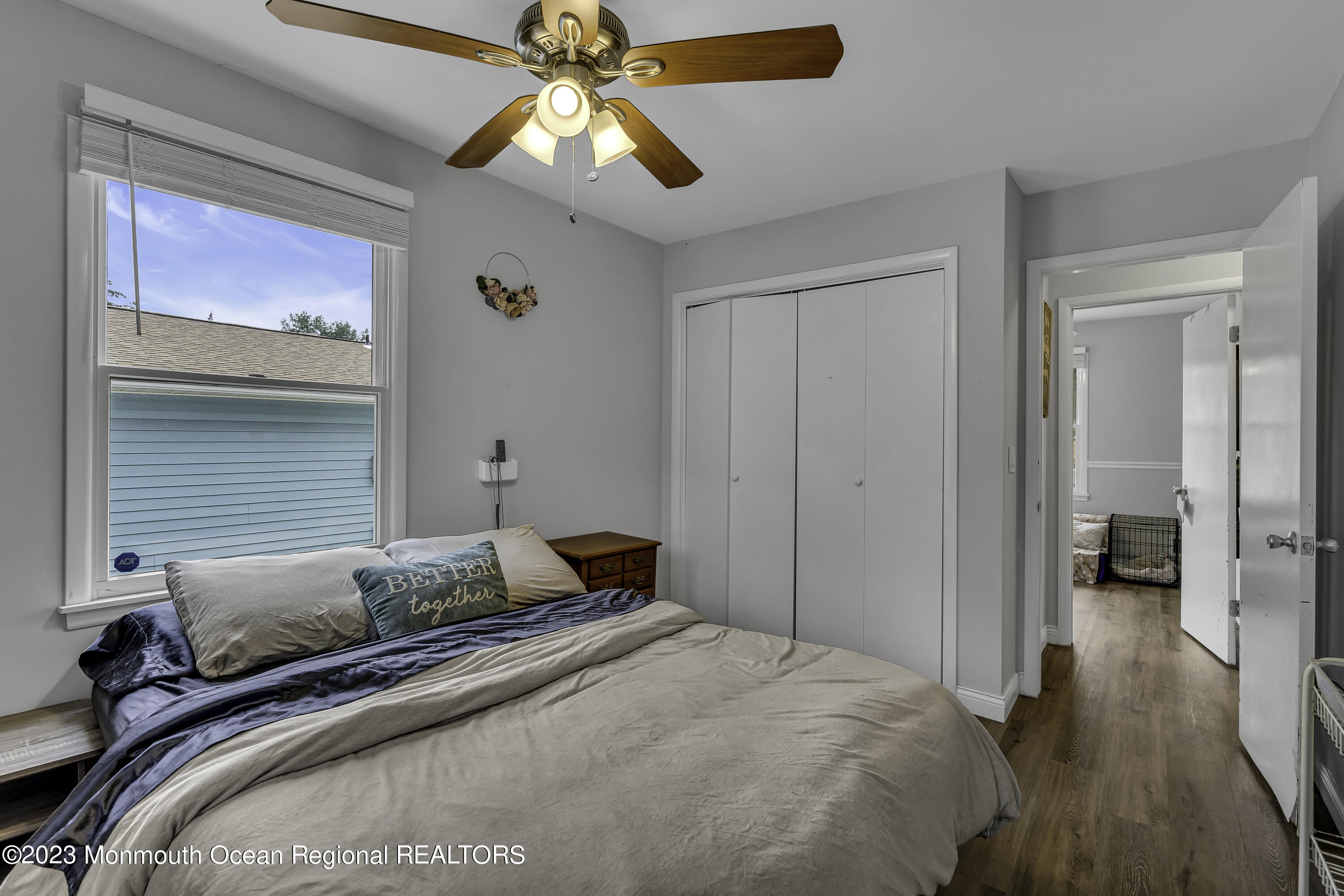 50 Central Avenue Waretown, NJ 08758 - Photo 24 of 35 a bedroom with a bed and a chandelier