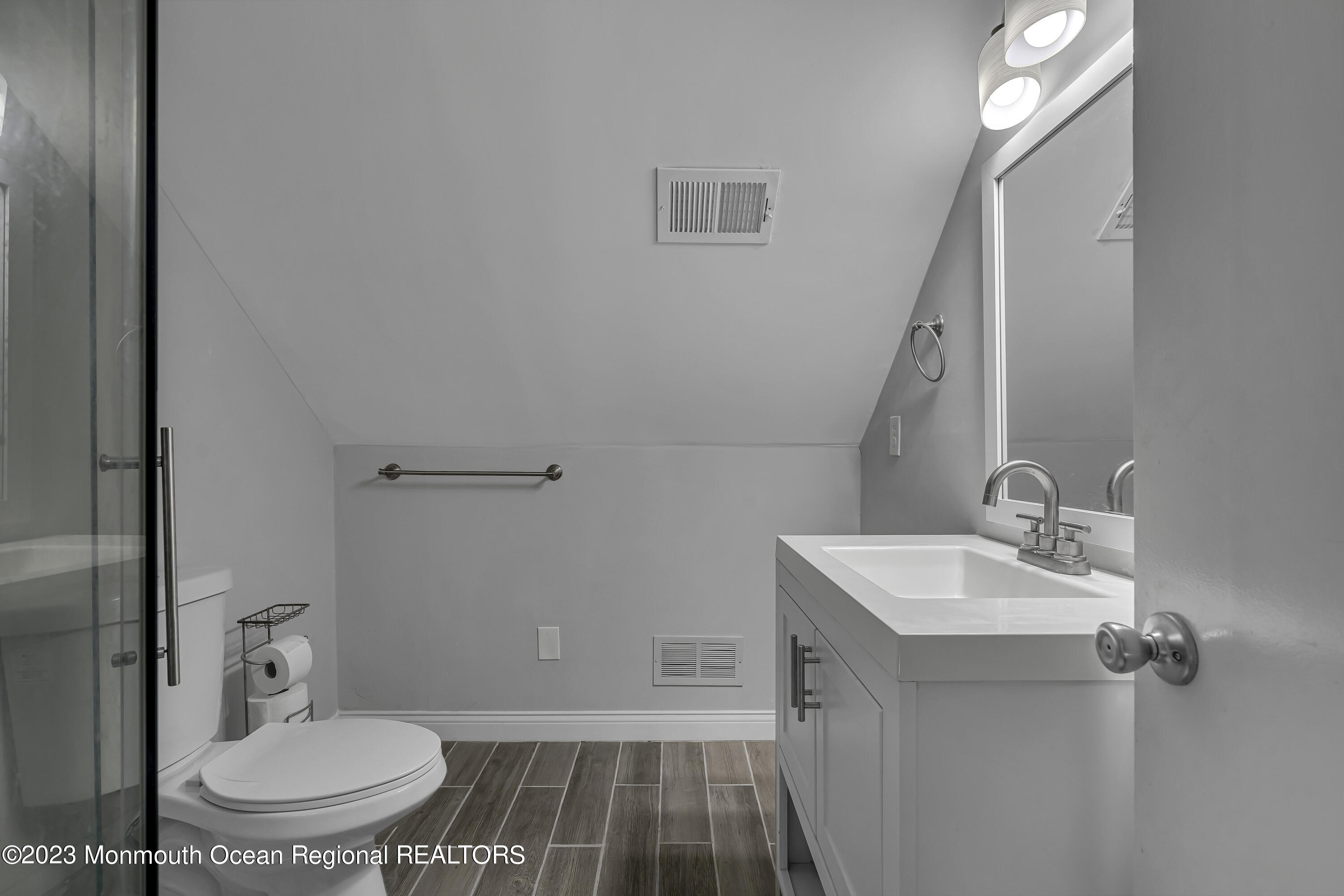 50 Central Avenue Waretown, NJ 08758 - Photo 25 of 35 a bathroom with a sink a toilet and mirror