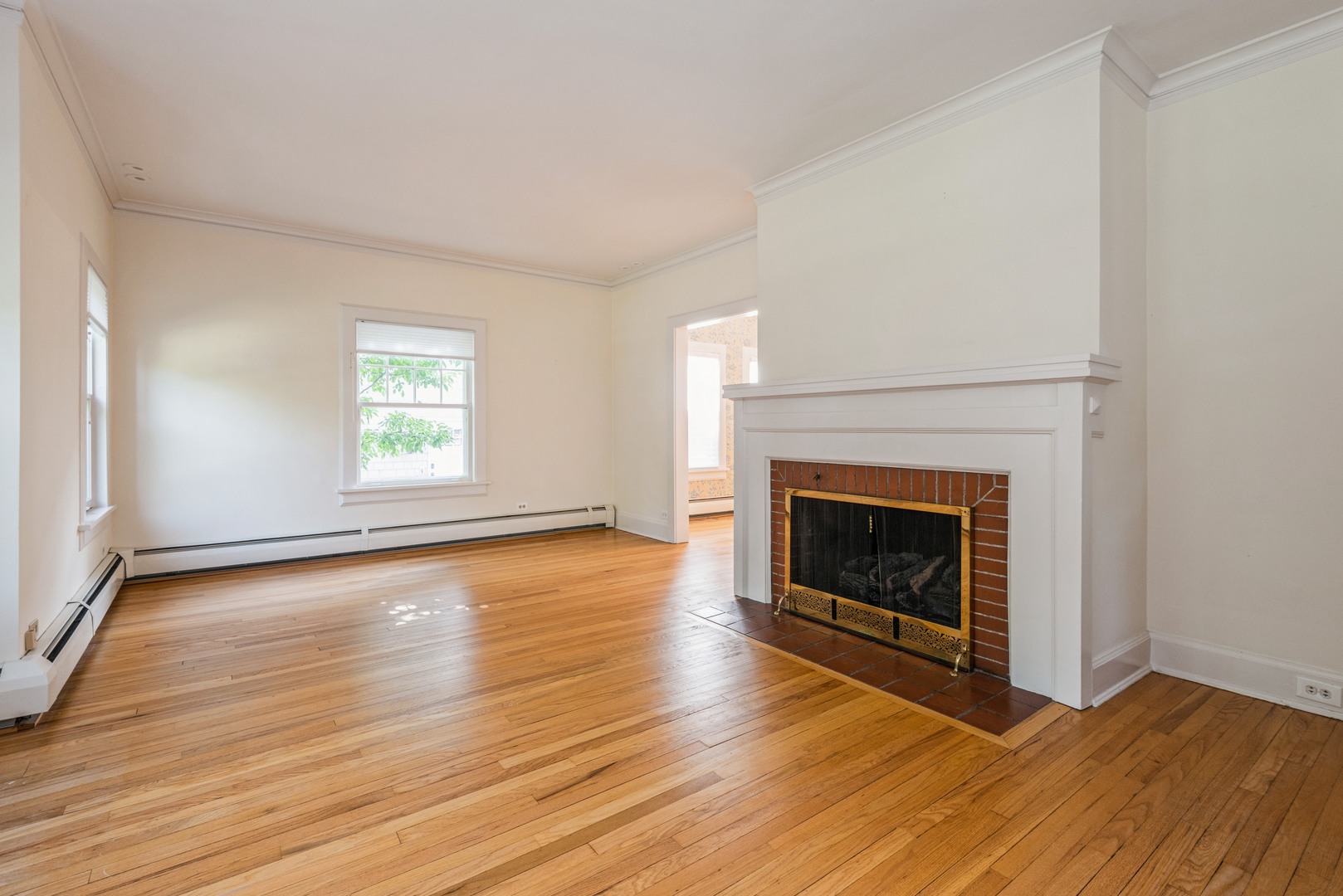 458 Sunset Road Winnetka, IL 60093 - Photo 3 of 17 an empty room with wooden floor fireplace and windows