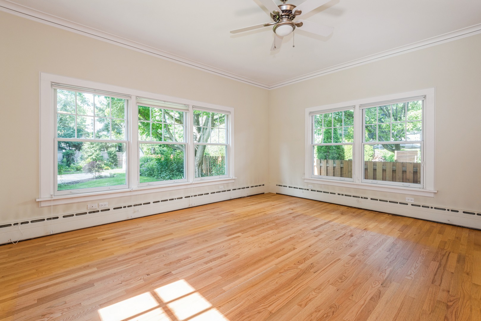 458 Sunset Road Winnetka, IL 60093 - Photo 8 of 17 a view of an empty room with wooden floor and a window