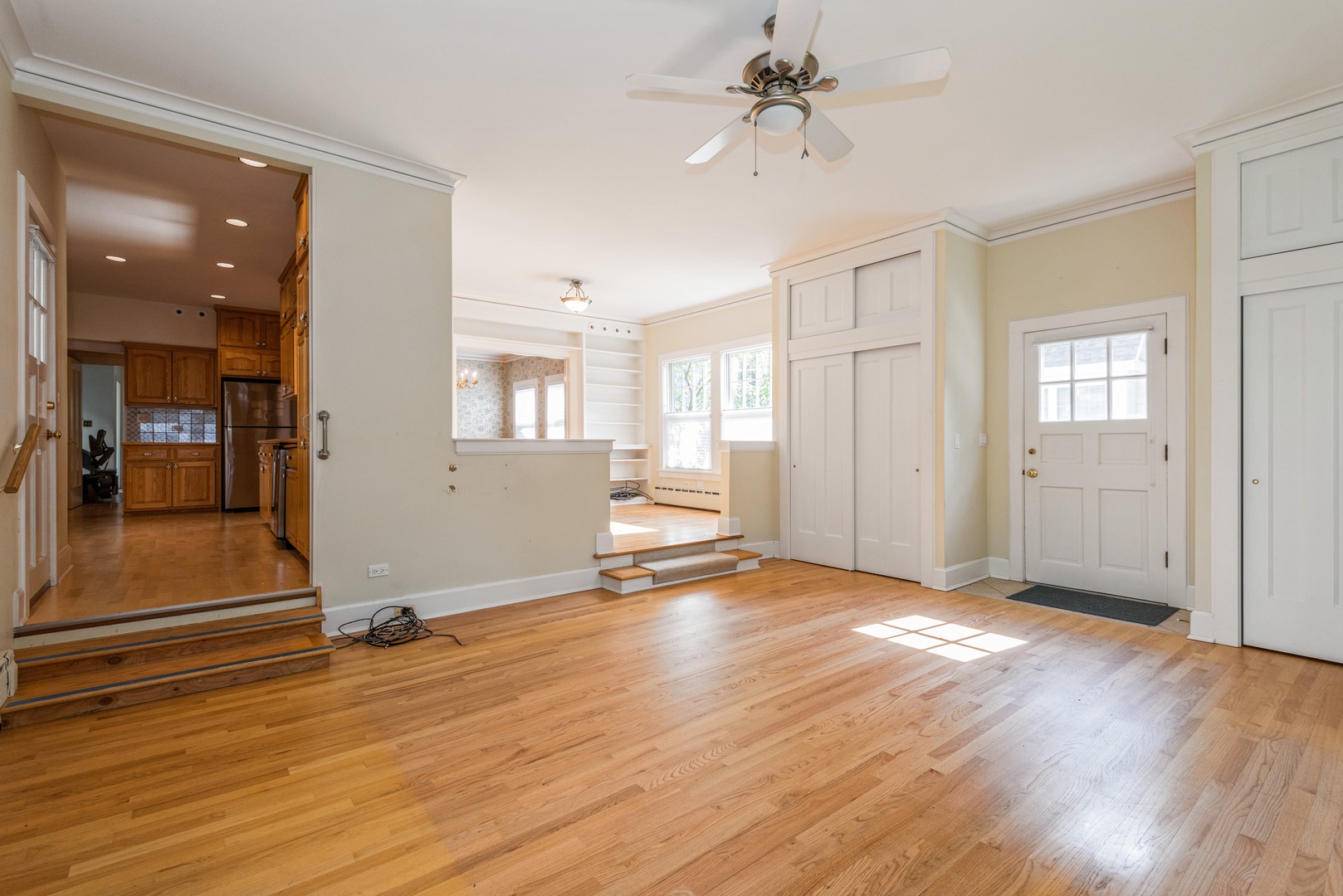 458 Sunset Road Winnetka, IL 60093 - Photo 9 of 17 a view of a livingroom with wooden floor and a ceiling fan