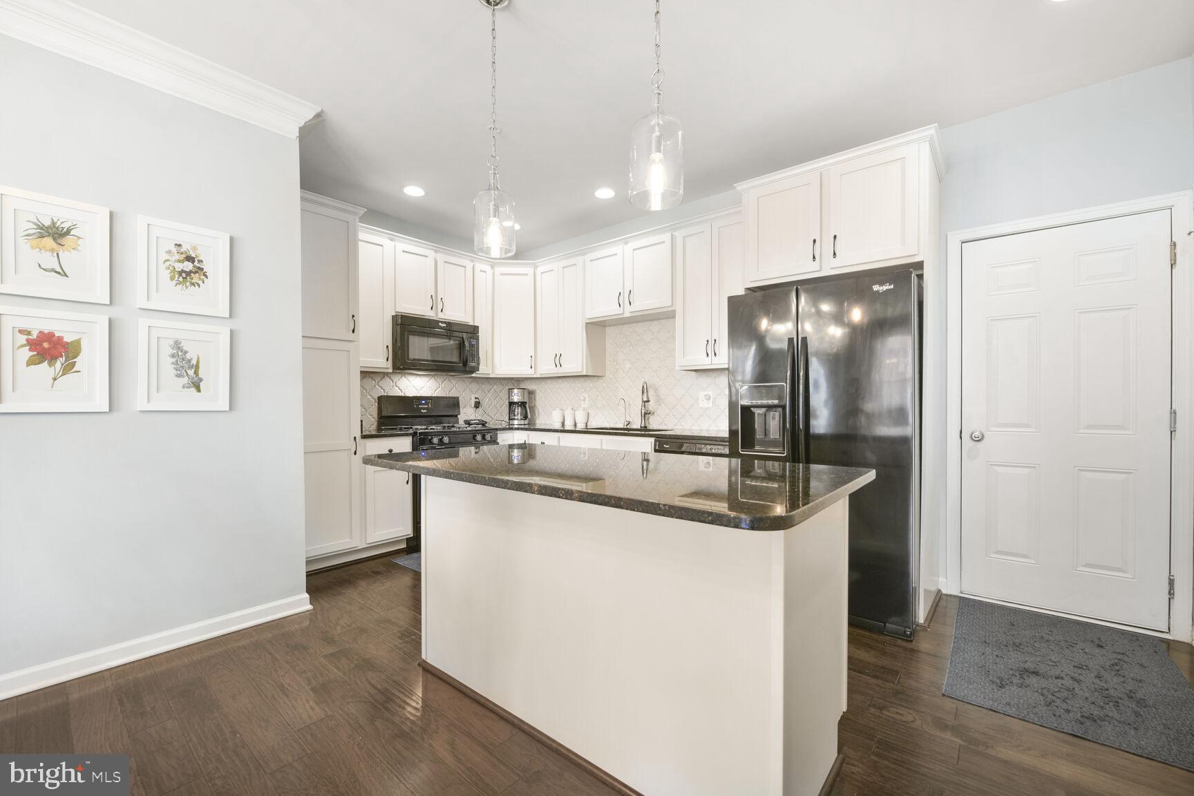 43037 Clarks Mill Terrace Ashburn, VA 20148 - Photo 12 of 28 a kitchen with stainless steel appliances granite countertop a refrigerator a stove a sink and a refrigerator