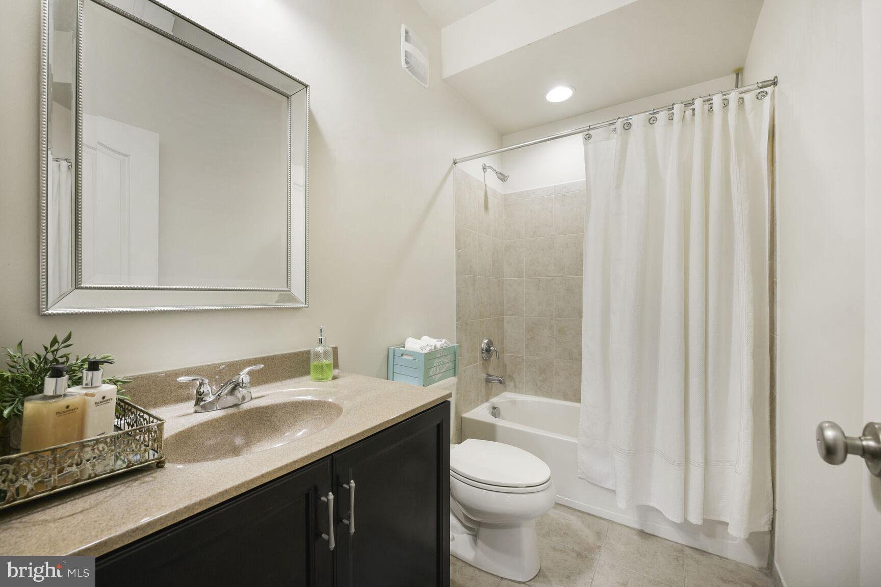 43037 Clarks Mill Terrace Ashburn, VA 20148 - Photo 26 of 28 a bathroom with a granite countertop sink toilet and shower
