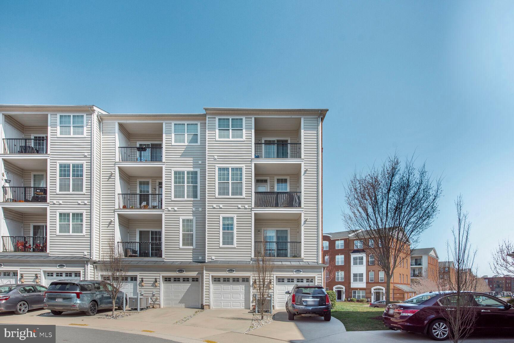 43037 Clarks Mill Terrace Ashburn, VA 20148 - Photo 27 of 28 a city street lined with buildings and cars parked