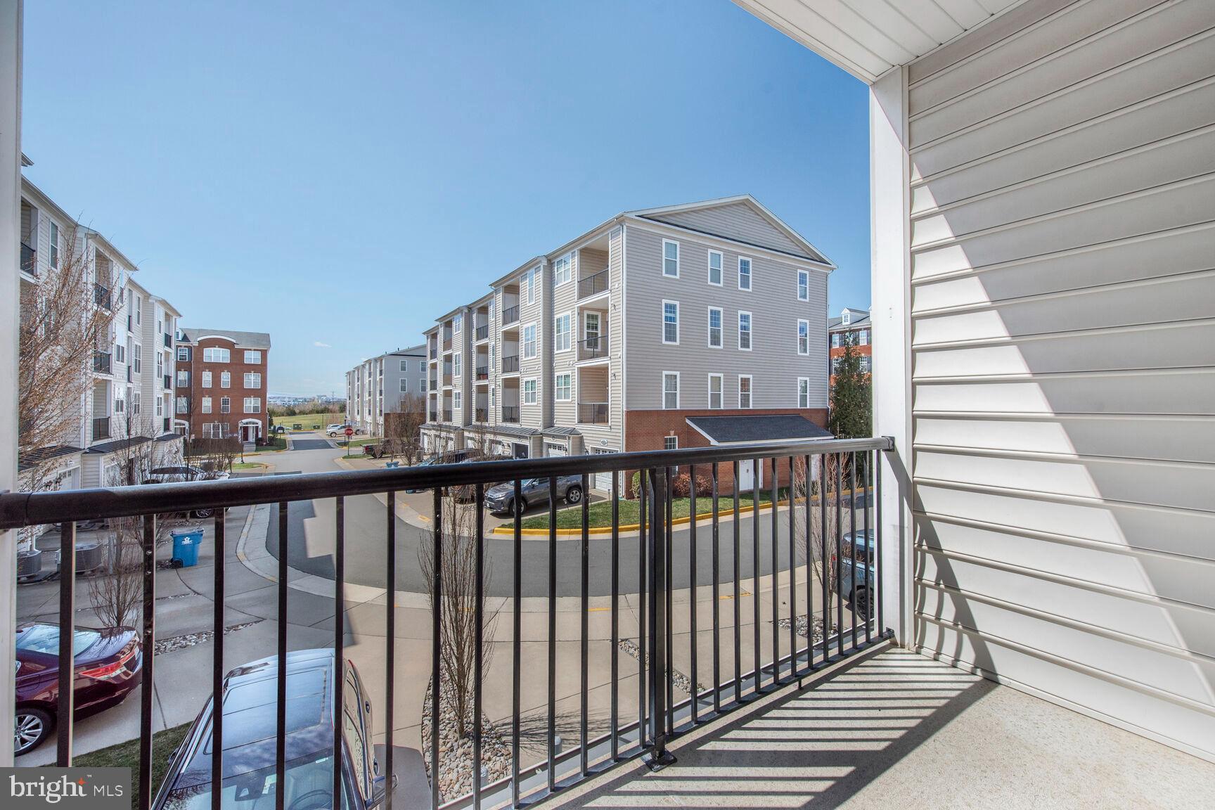 43037 Clarks Mill Terrace Ashburn, VA 20148 - Photo 28 of 28 a view of a balcony with wooden floor and fence
